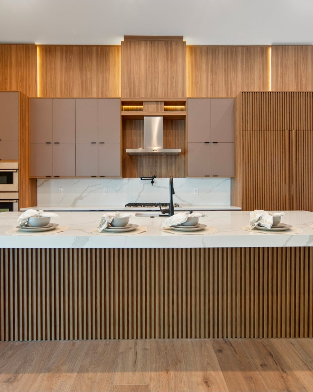 Calacatta waterfall island with walnut slat base